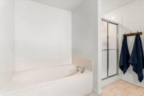 a bathroom with a bathtub and a shower