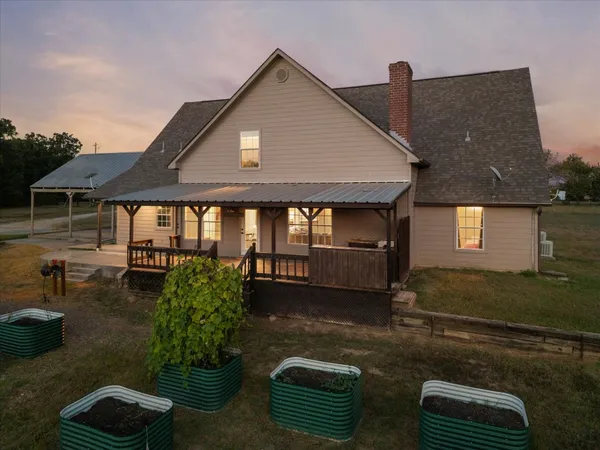 an aerial view of a house with garden space and ocean view