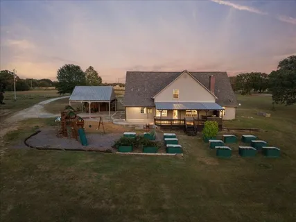 a aerial view of a house with swimming pool and a yard