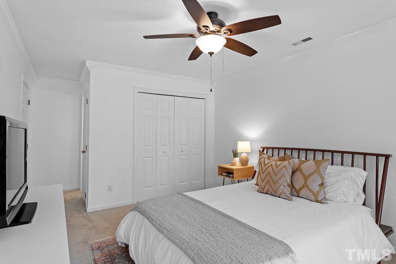 4428 Liverpool Lane Raleigh, NC 27604 - Photo 15 of 24 a bedroom with a large bed and a tv