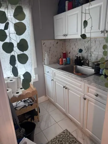 a kitchen with a sink a stove and cabinets