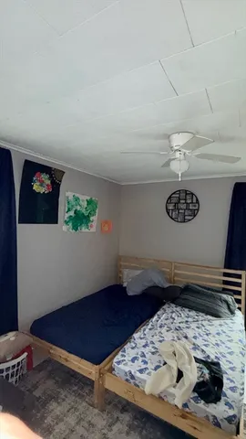 a room with wooden floor and book shelf