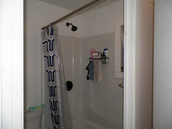 a bathroom with a shower and a glass door