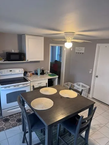 a kitchen with a table chairs and a stove