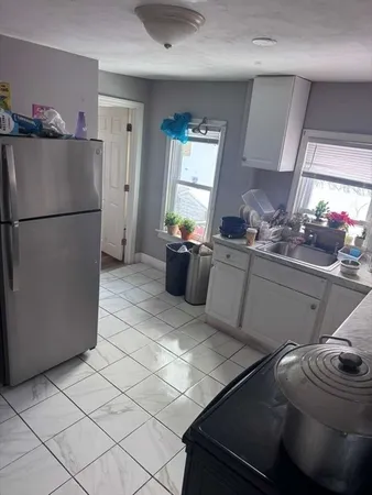 a kitchen with a sink appliances and cabinets