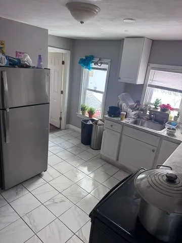 a kitchen with a sink appliances and cabinets