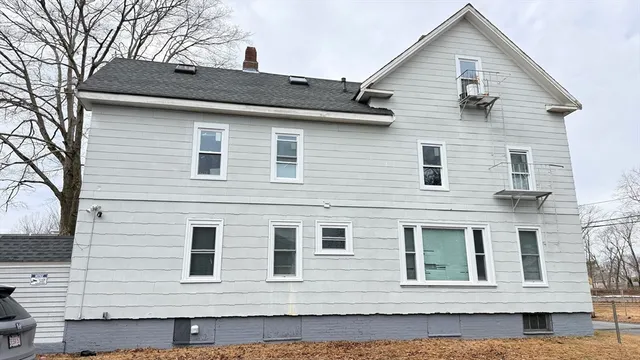 a view of a brick house with large windows