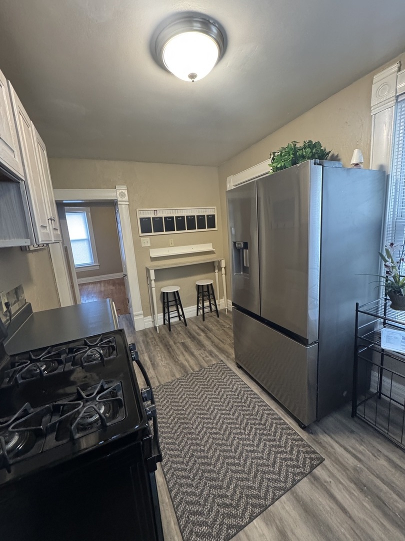 1108 East Main Street Urbana, IL 61802 - Photo 3 of 10 a kitchen with stainless steel appliances granite countertop a refrigerator and a stove