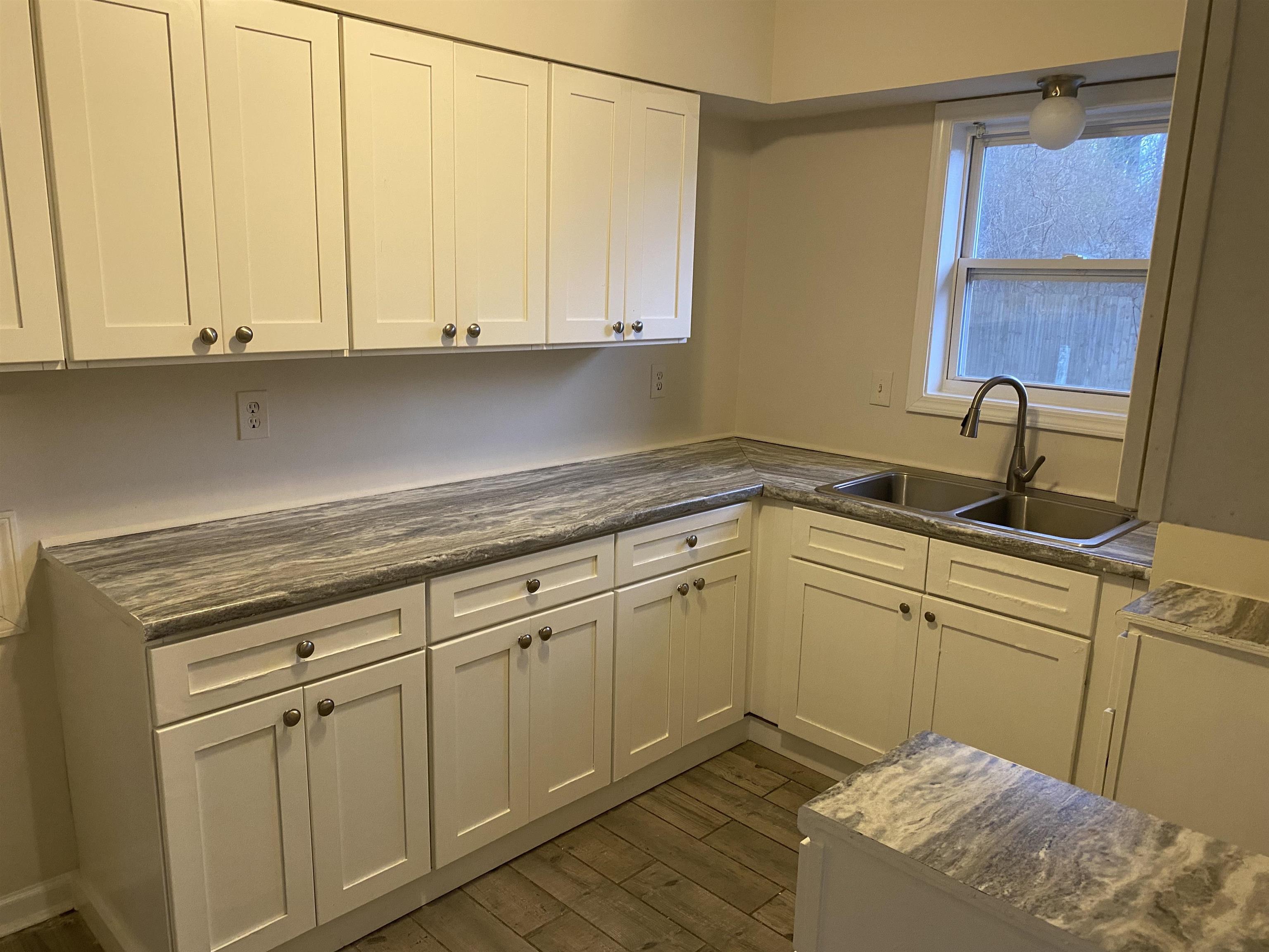 777 Archie Drive Memphis, TN 38127 - Photo 13 of 15 a kitchen with white cabinets and sink