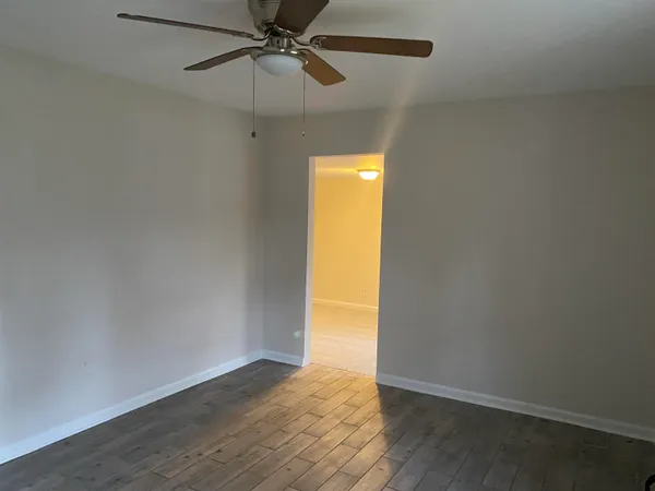 an empty room with a empty space and a ceiling fan