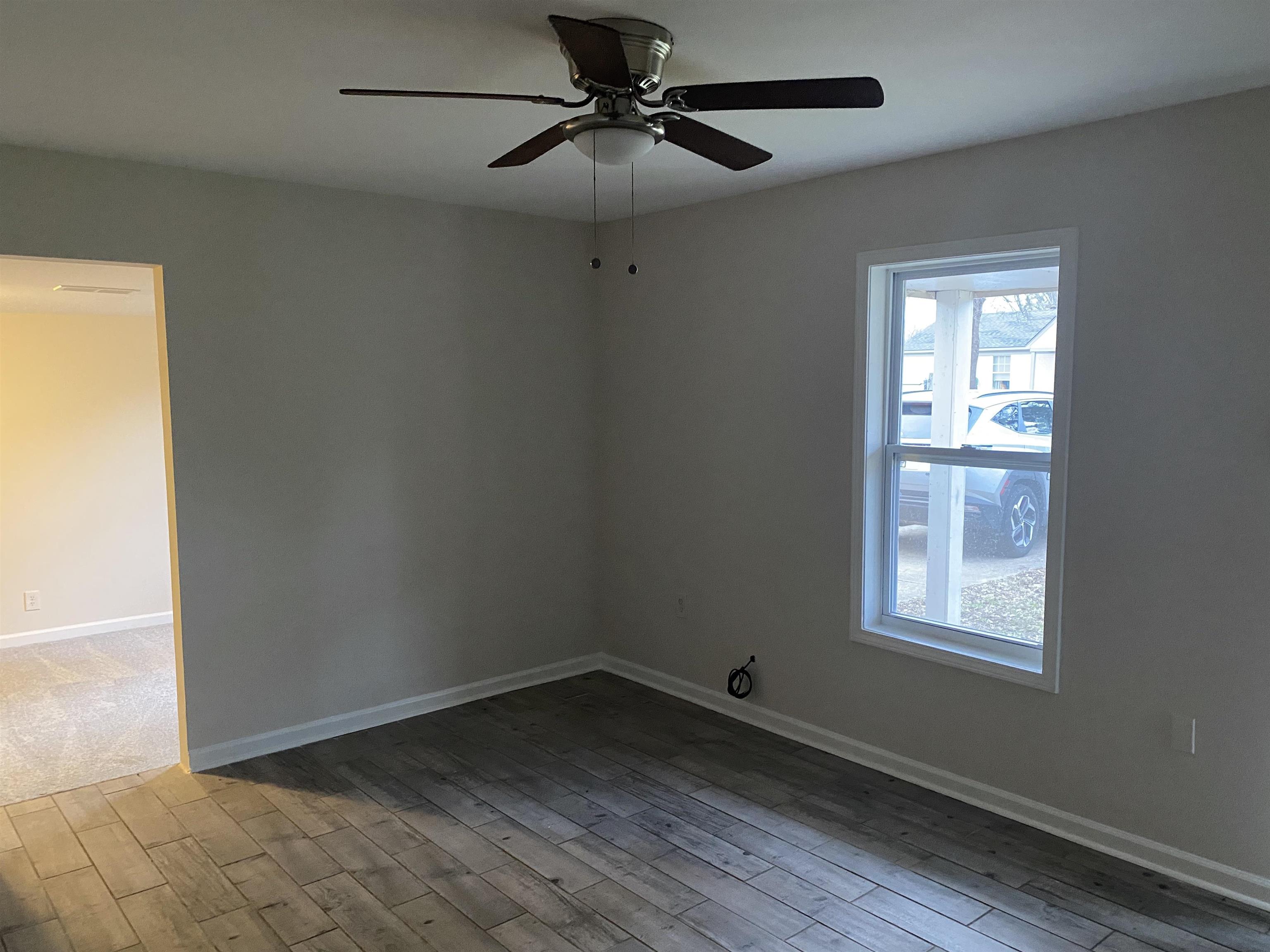 777 Archie Drive Memphis, TN 38127 - Photo 5 of 15 a view of an empty room with a window and wooden floor