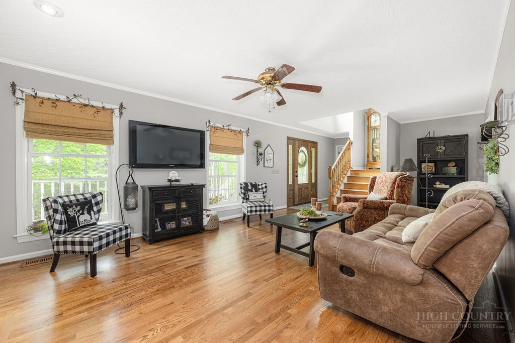 970 Vox Road Sparta, NC 28675 - Photo 19 of 50 a living room with furniture a fireplace and a flat screen tv