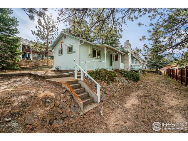 a backyard of a house with barbeque oven table and chairs