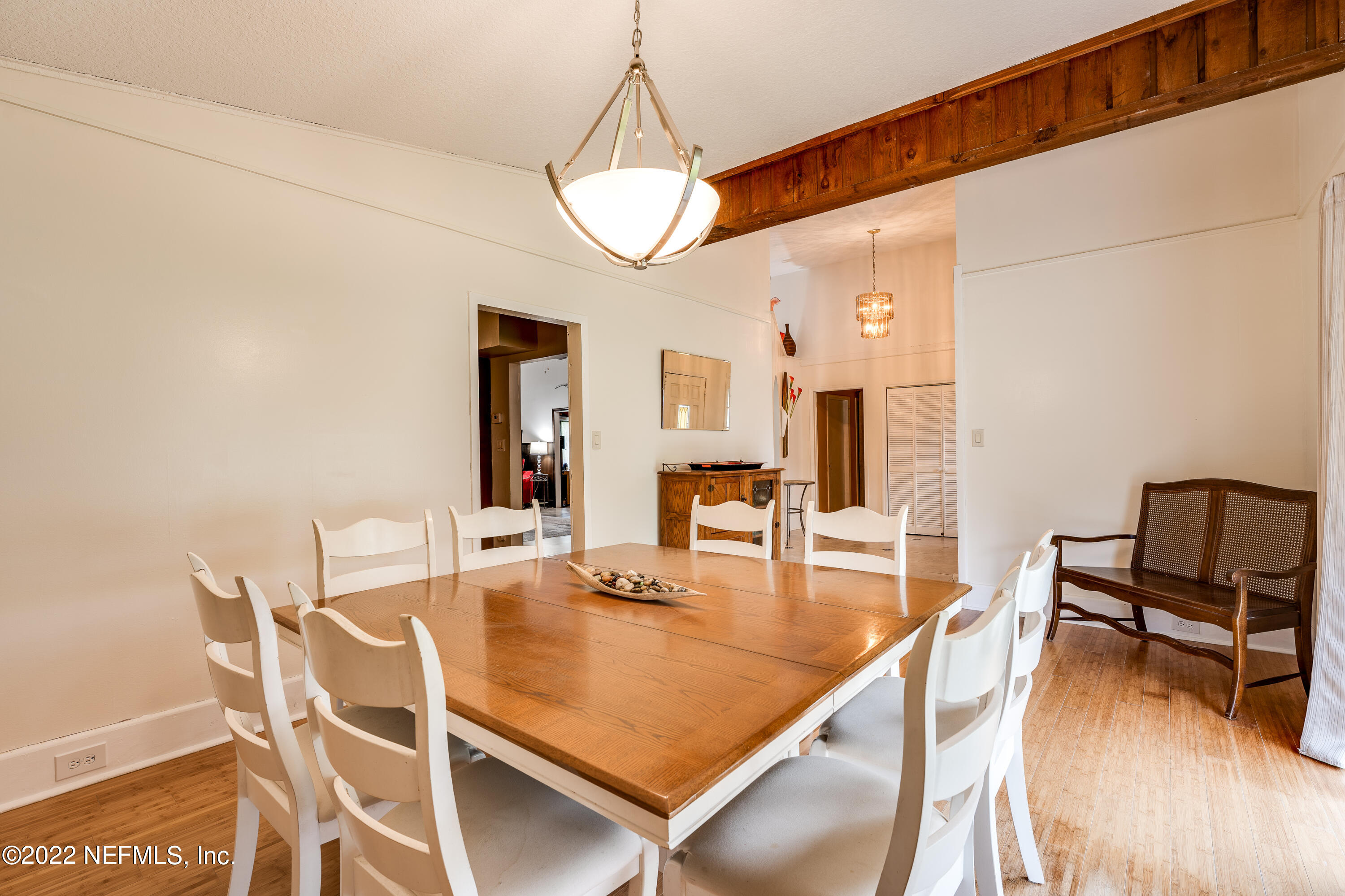 54528 Vikki Road Callahan, FL 32011 - Photo 11 of 41 a dining hall with couches a dining table and chairs with wooden floor