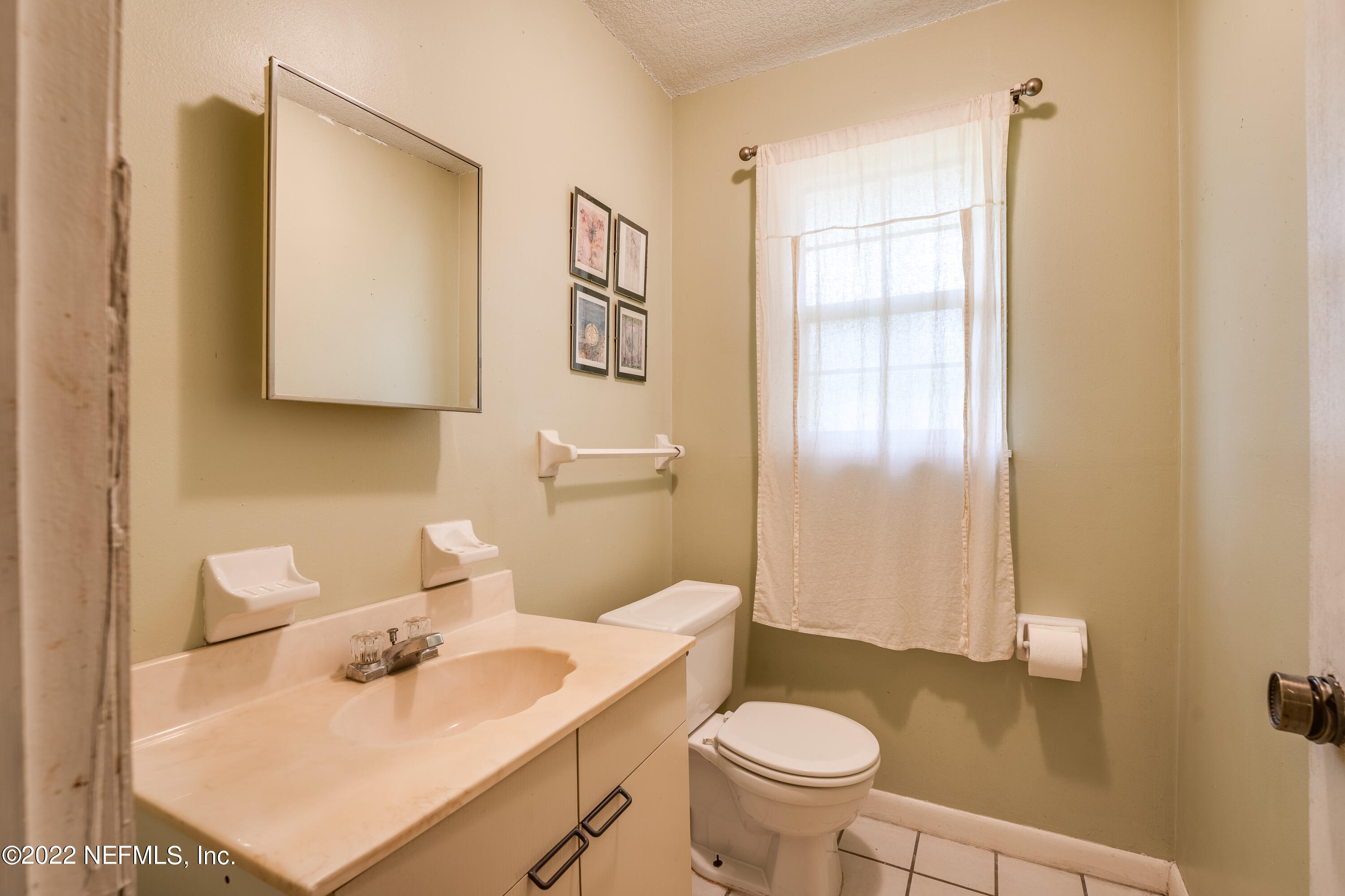54528 Vikki Road Callahan, FL 32011 - Photo 23 of 41 a bathroom with a sink toilet and mirror