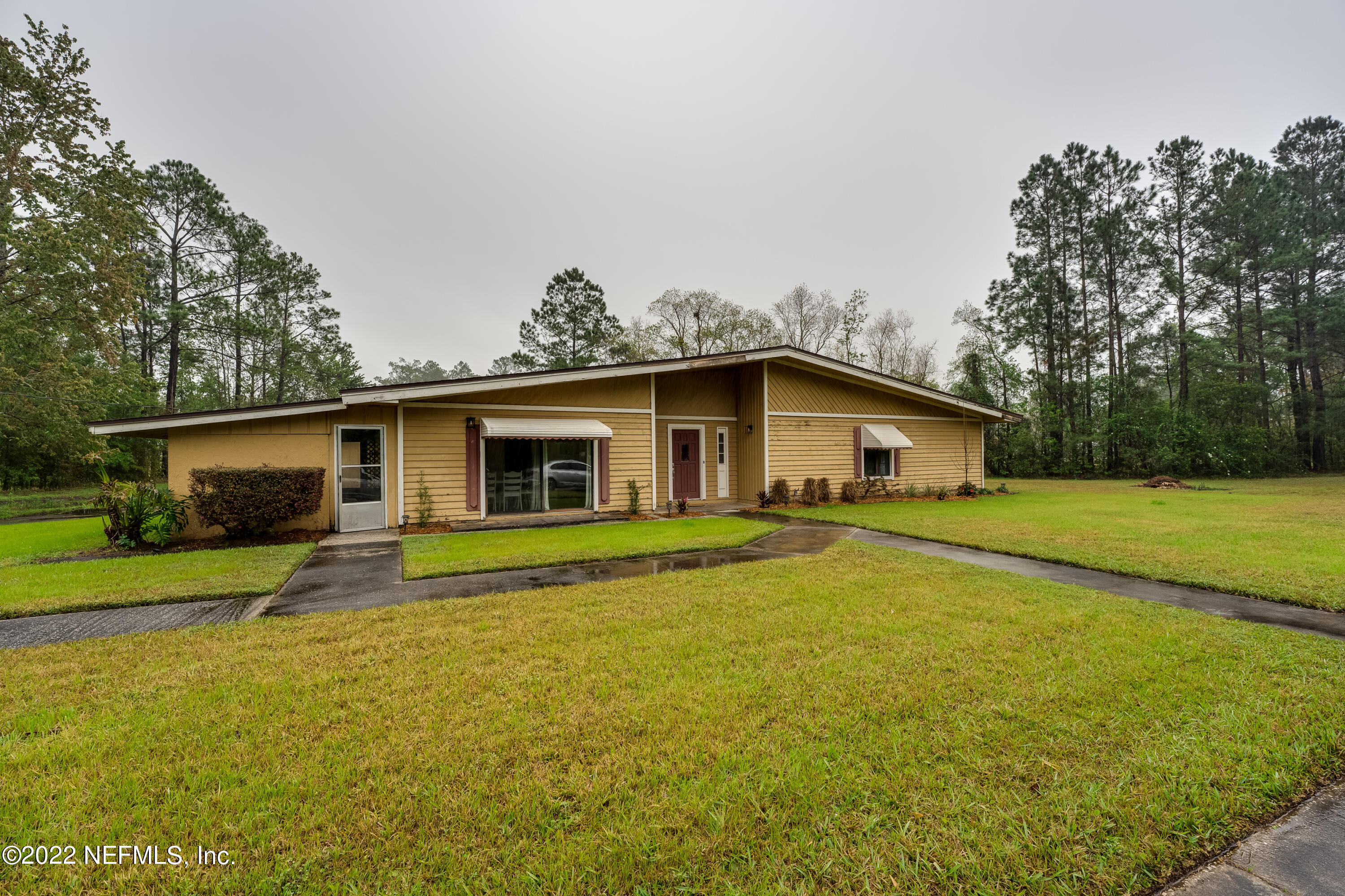 54528 Vikki Road Callahan, FL 32011 - Photo 3 of 41 a front view of house with yard and trees