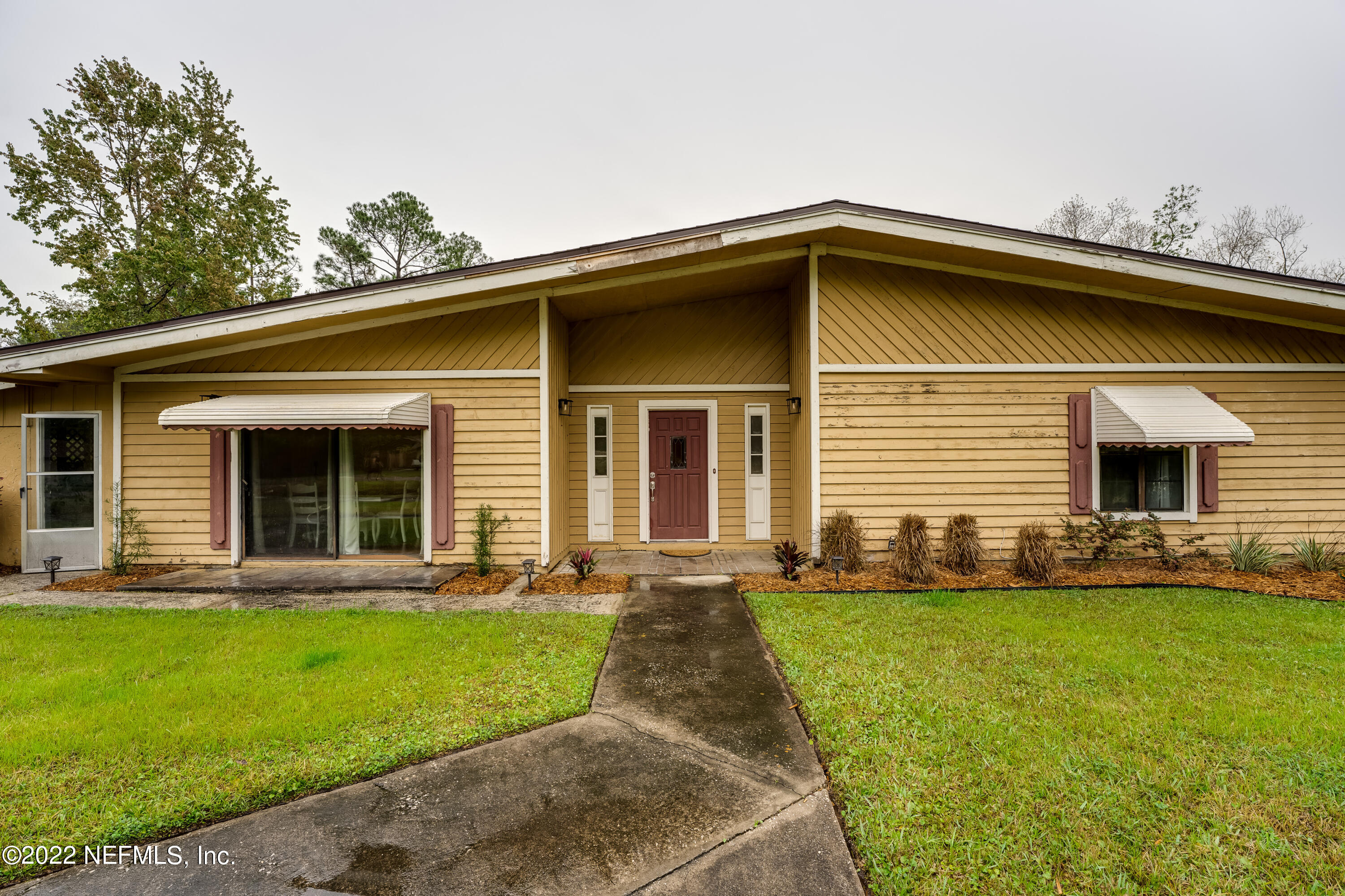 54528 Vikki Road Callahan, FL 32011 - Photo 5 of 41 a front view of a house with a yard and porch