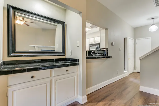 a view of a kitchen with a sink and dishwasher wooden floor