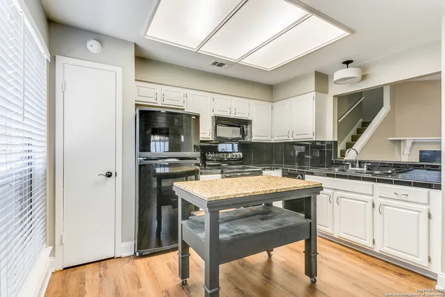 a kitchen with a stove a sink and a refrigerator