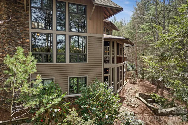 a front view of a building with large trees