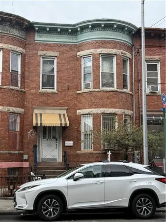 a front view of a house with parking space