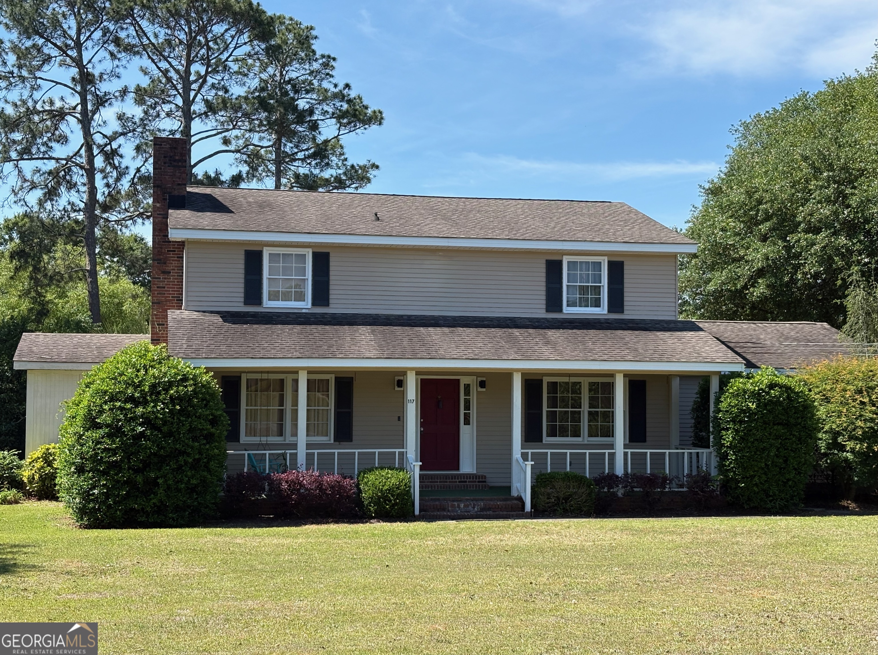 a front view of a house with garden