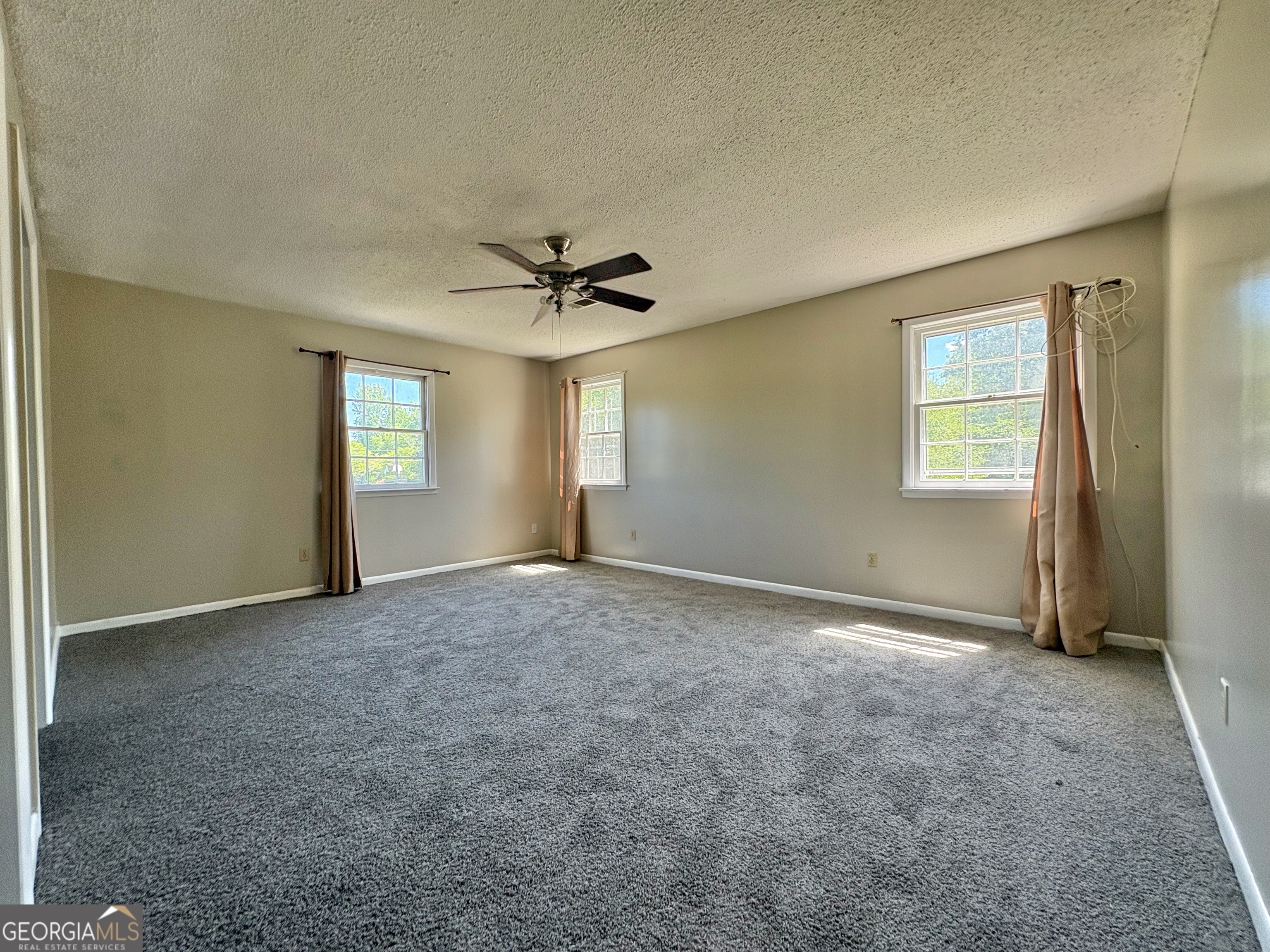 117 Laura Lane Fort Valley, GA 31030 - Photo 15 of 28 an empty room with windows and chandelier fan