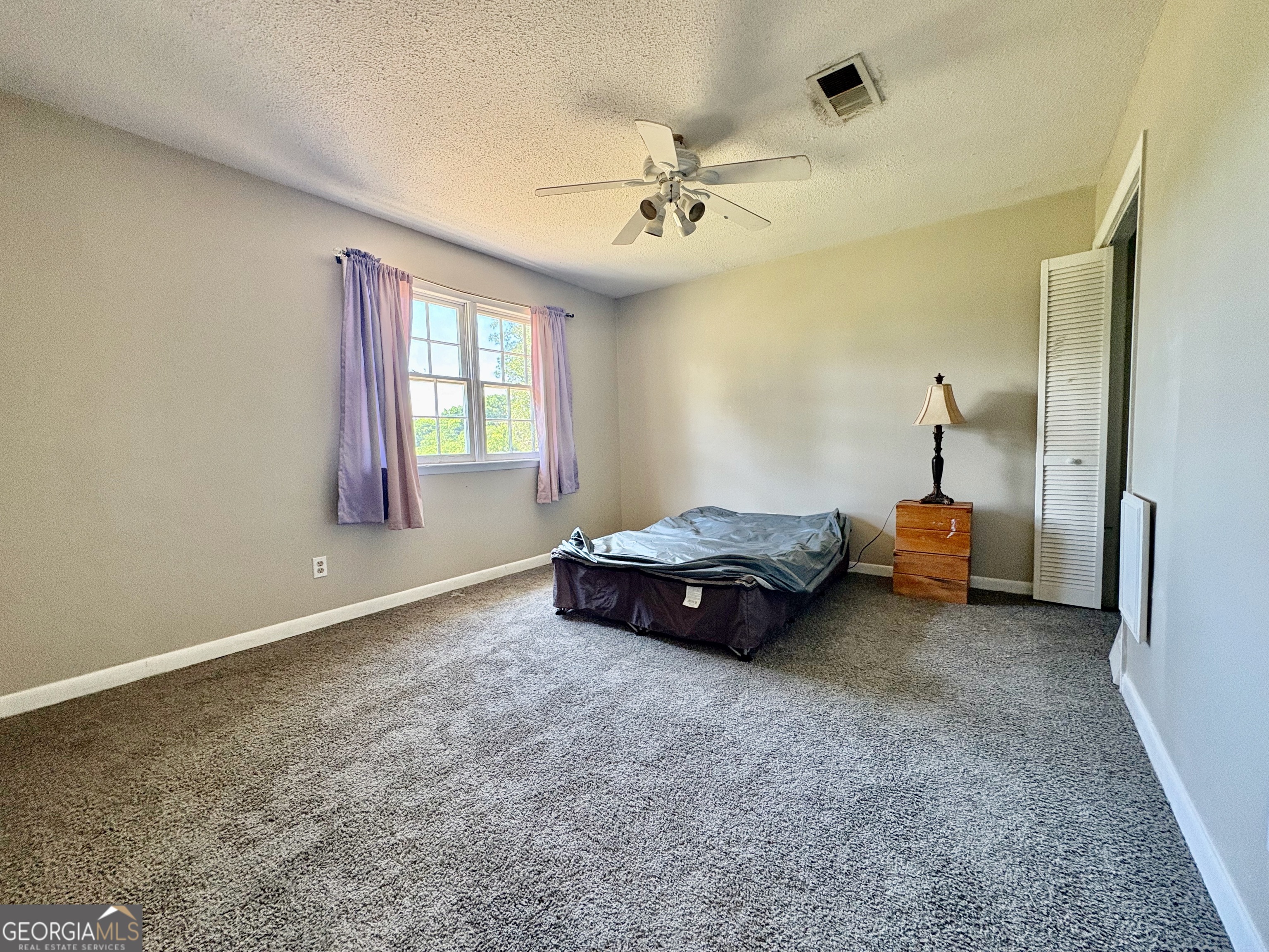 117 Laura Lane Fort Valley, GA 31030 - Photo 17 of 28 a bed room with a bed and a chandelier