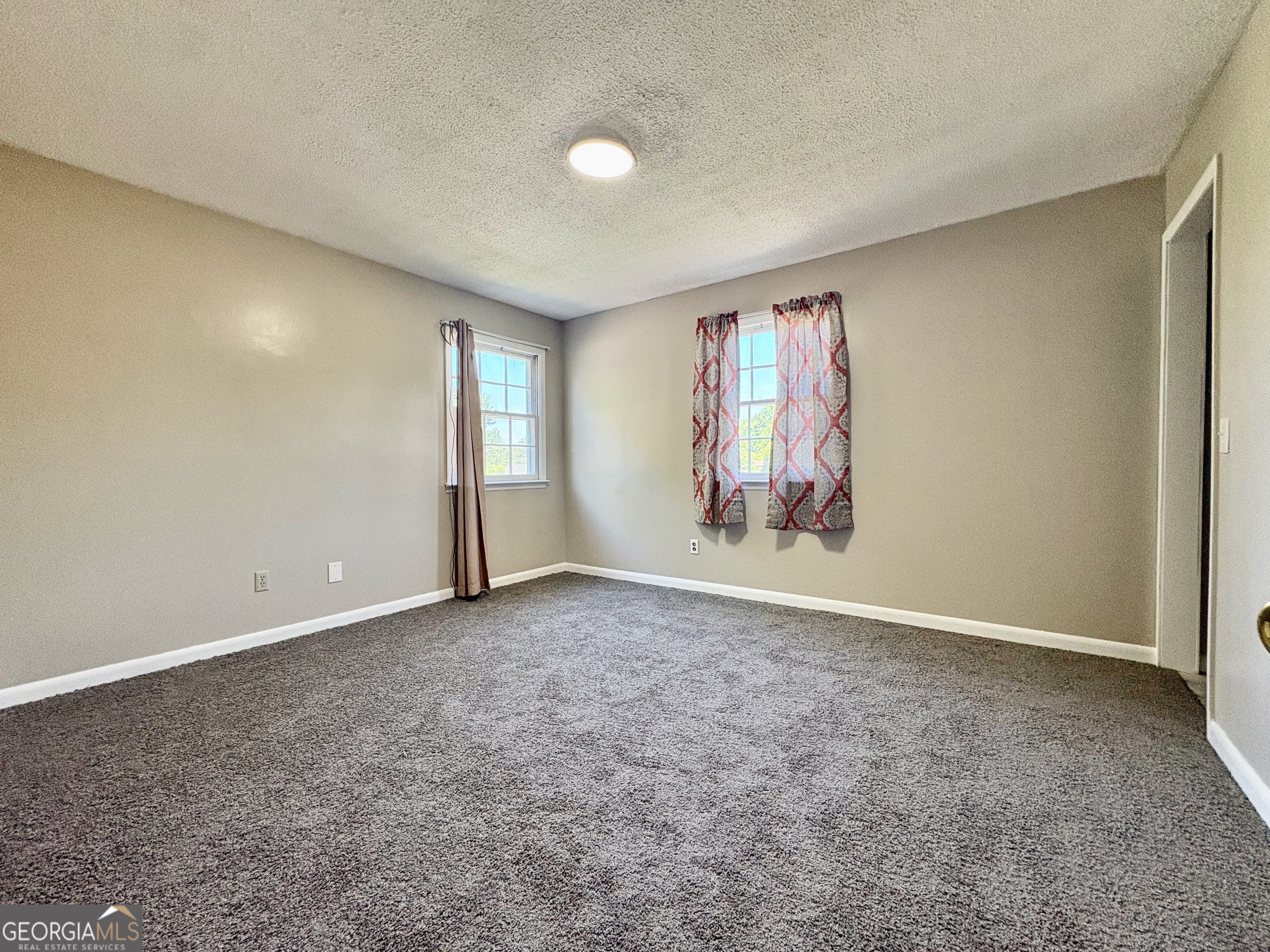 117 Laura Lane Fort Valley, GA 31030 - Photo 18 of 28 an empty room with windows and cabinet