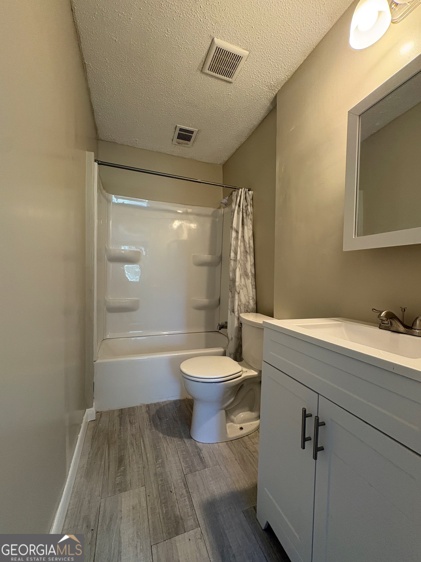 117 Laura Lane Fort Valley, GA 31030 - Photo 20 of 28 a bathroom with a granite countertop toilet a sink and bathtub