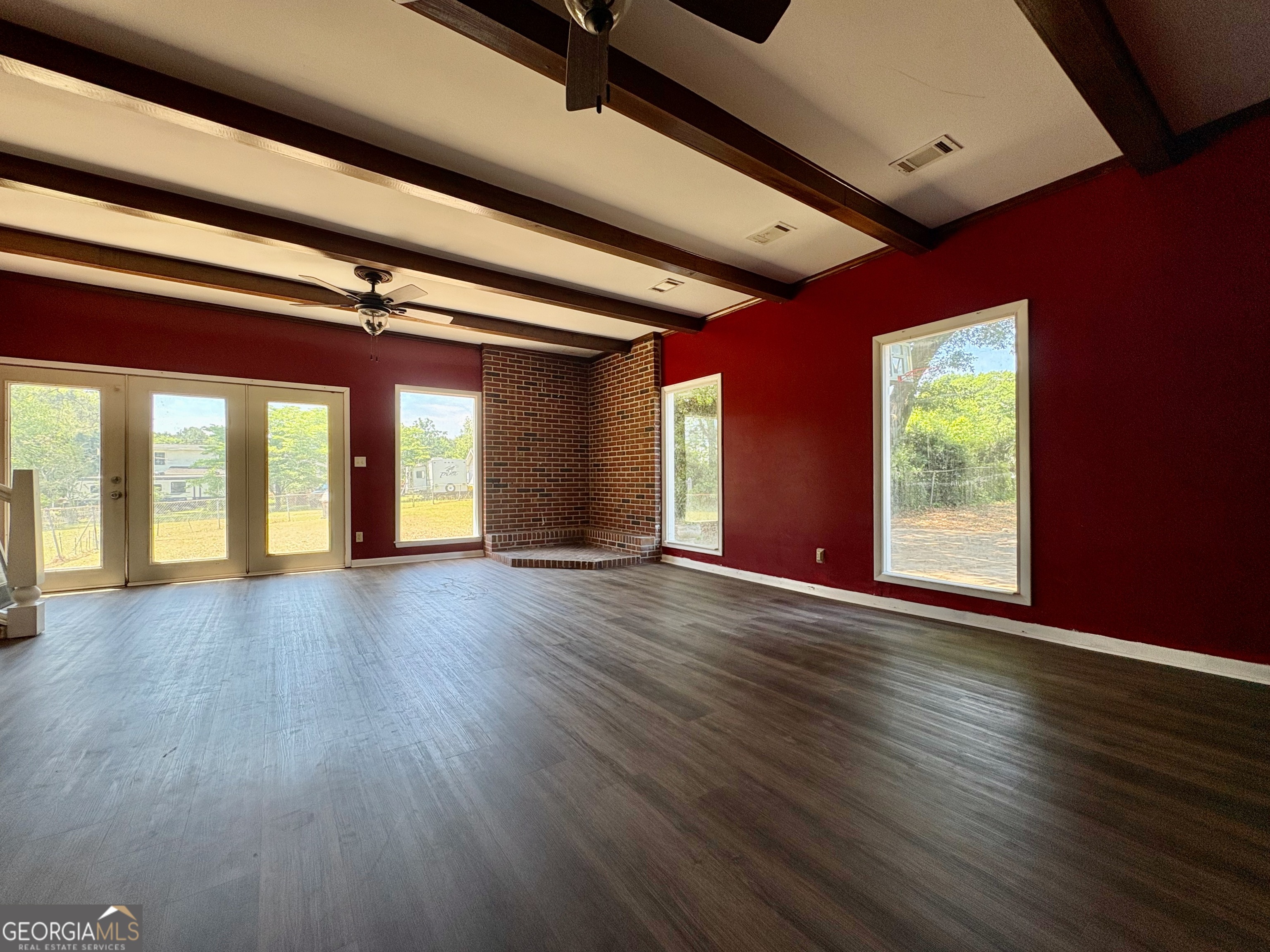 117 Laura Lane Fort Valley, GA 31030 - Photo 6 of 28 a view of an empty room with wooden floor and windows