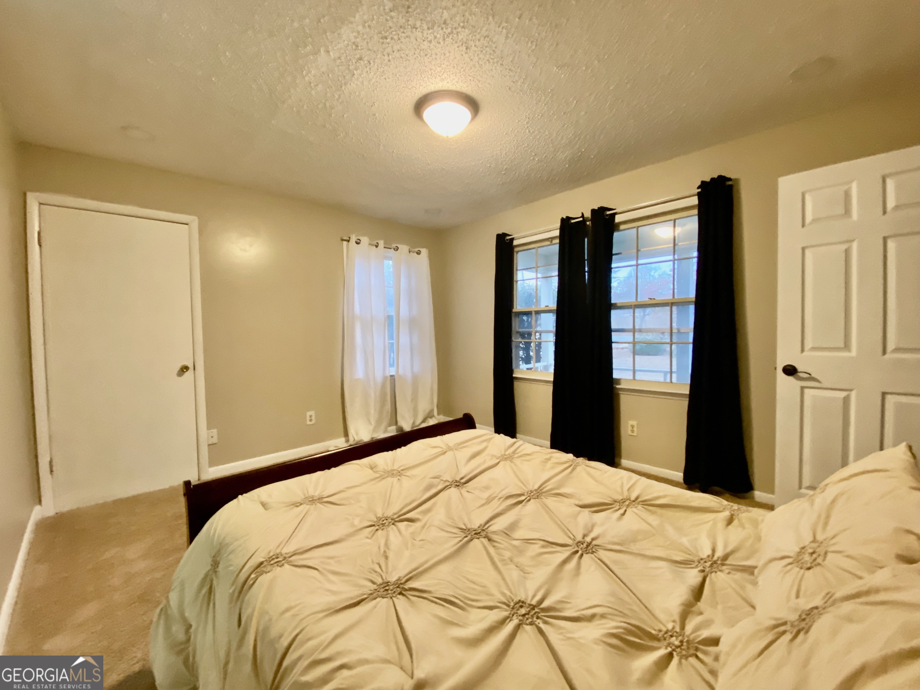 117 Laura Lane Fort Valley, GA 31030 - Photo 7 of 28 a bedroom with a bed and a large mirror