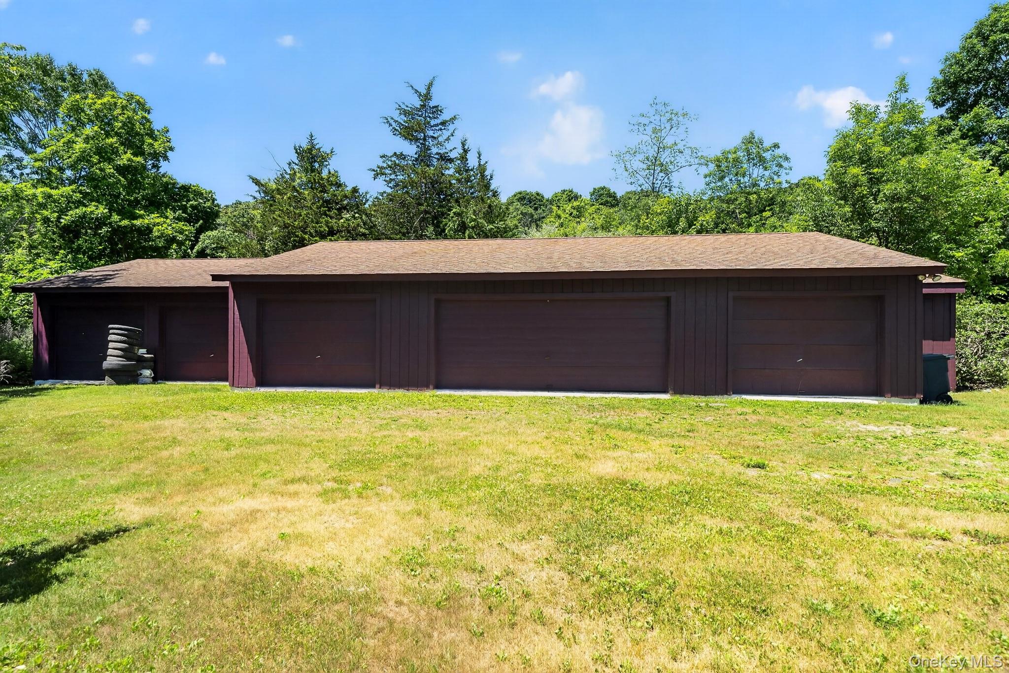 424 Laroe Road Chester, NY 10918 - Photo 22 of 43 Expansive garage structure featuring four individual bays with brown garage doors