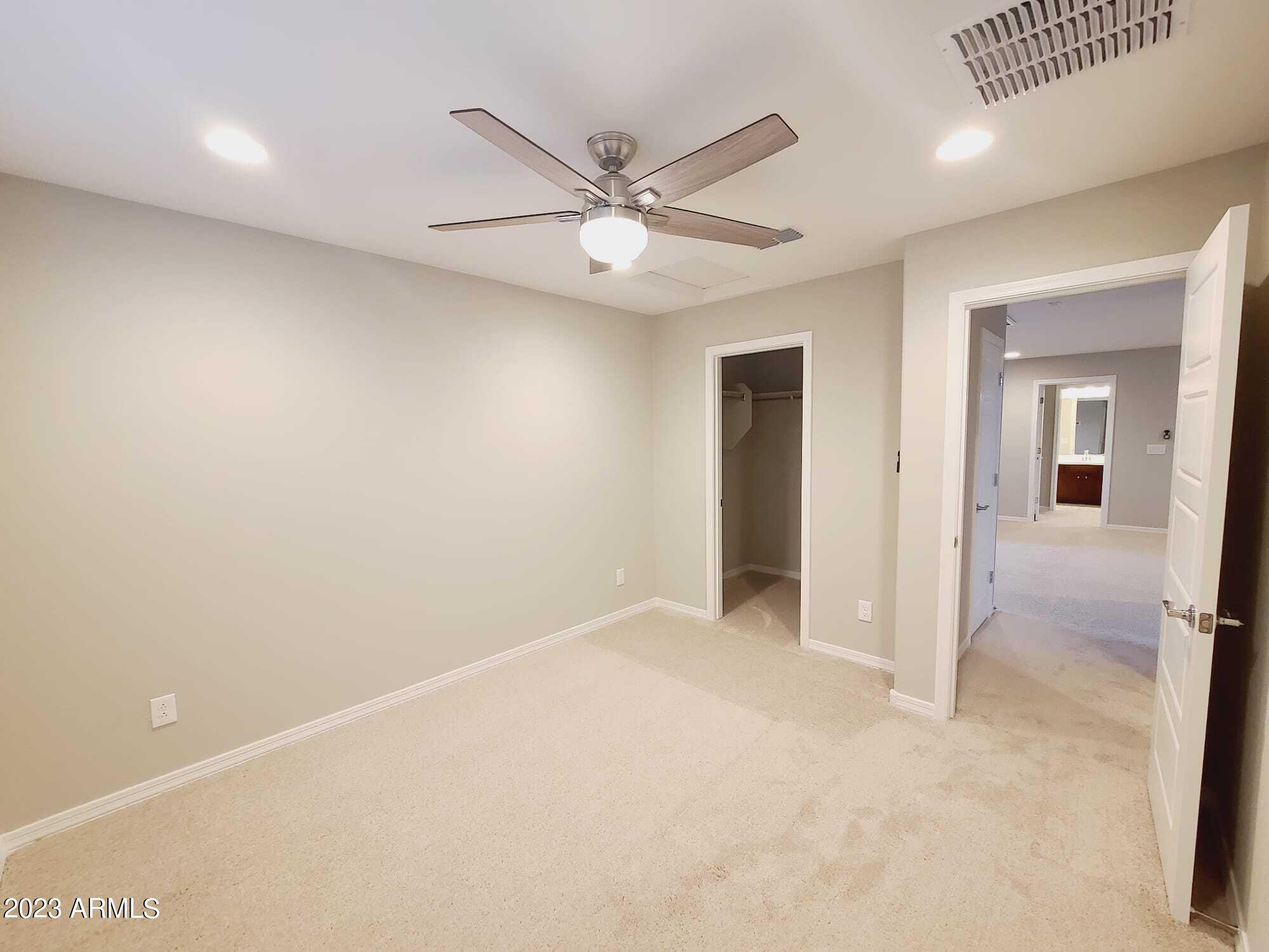 9013 West Marshall Avenue Glendale, AZ 85305 - Photo 21 of 22 an empty room with closet and a ceiling fan
