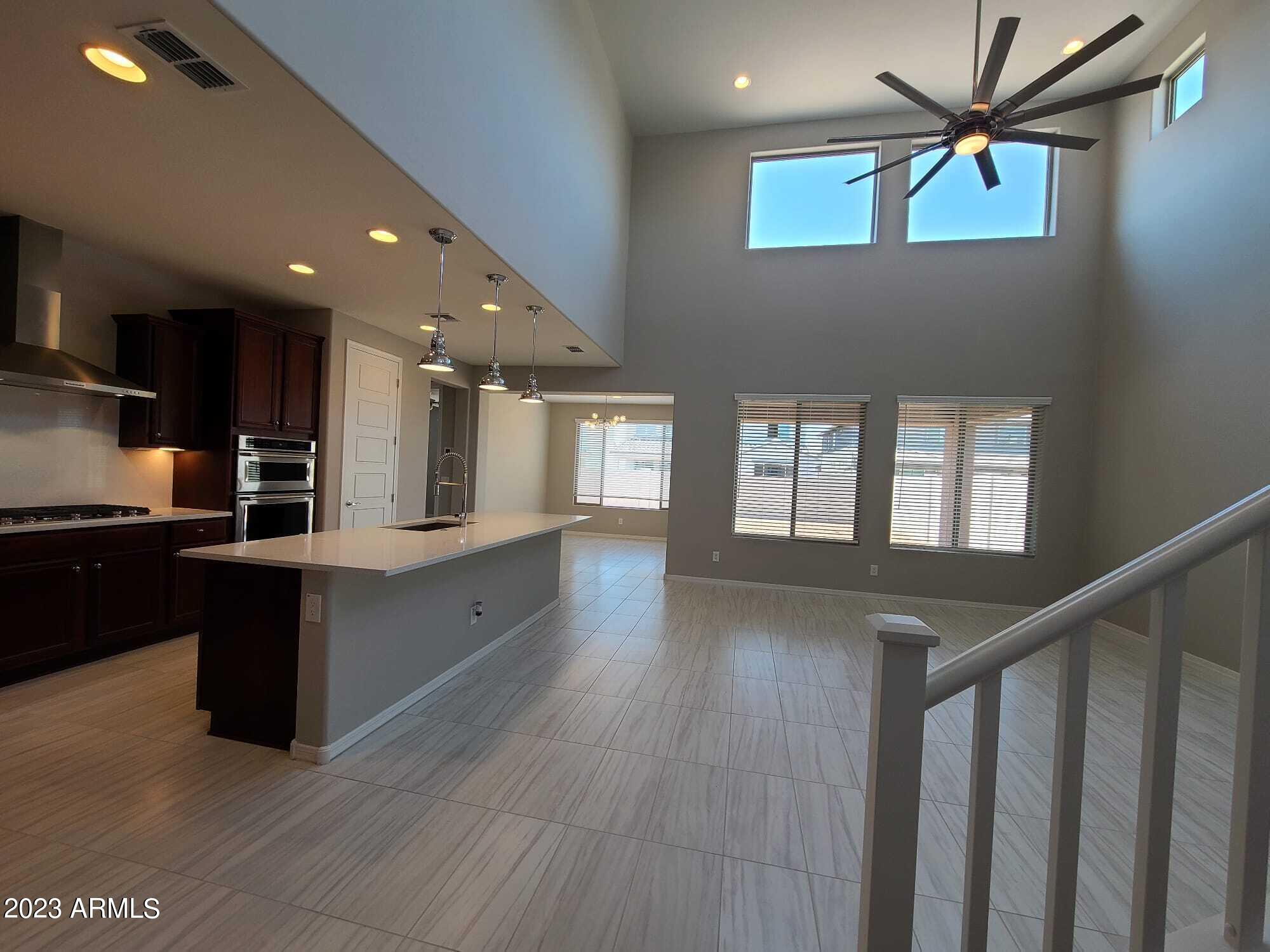 9013 West Marshall Avenue Glendale, AZ 85305 - Photo 6 of 22 a kitchen with stainless steel appliances kitchen island granite countertop a stove a sink and a refrigerator