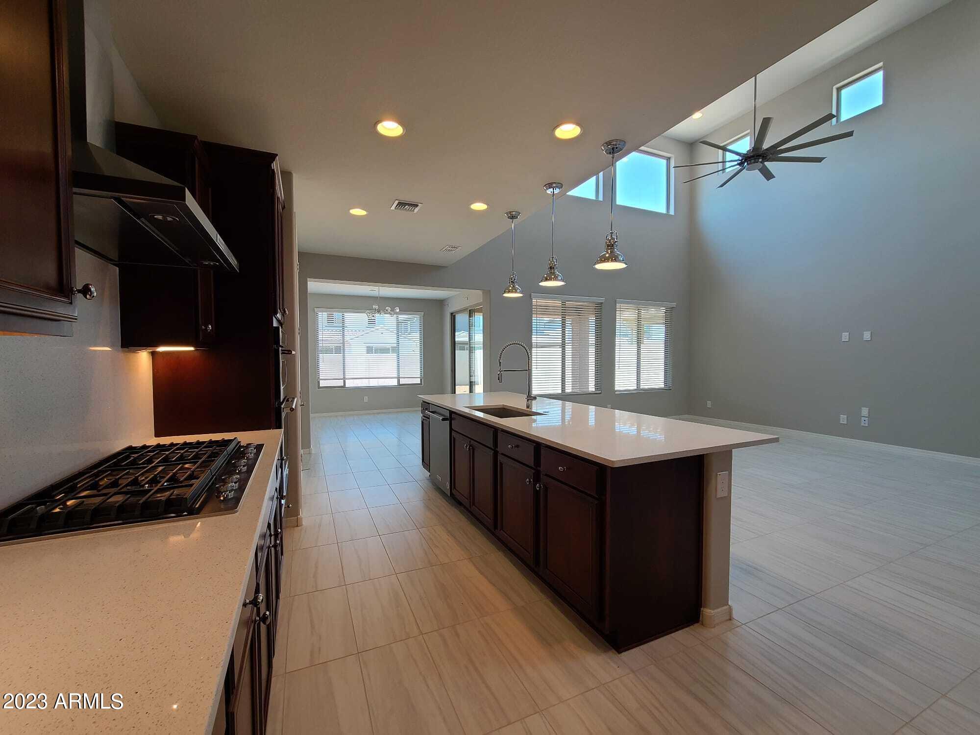 9013 West Marshall Avenue Glendale, AZ 85305 - Photo 9 of 22 a kitchen with wooden cabinets and a sink