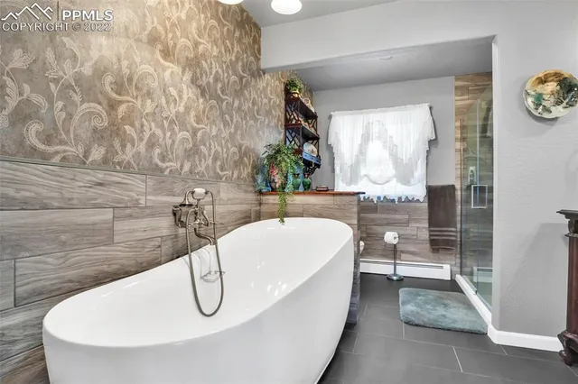 a bathroom with a white tub shower and sink