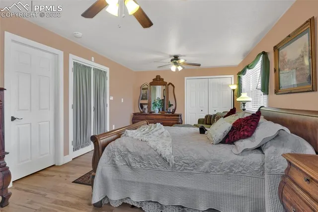 a bedroom with a large bed and a chandelier
