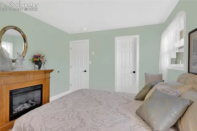 a bedroom with a bed and a fireplace