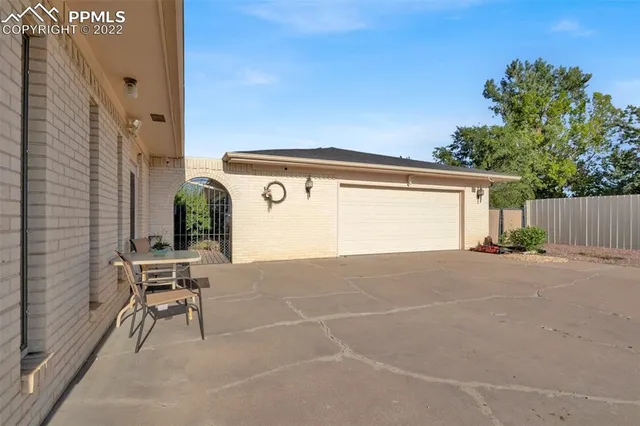 a view of backyard with a chair and table