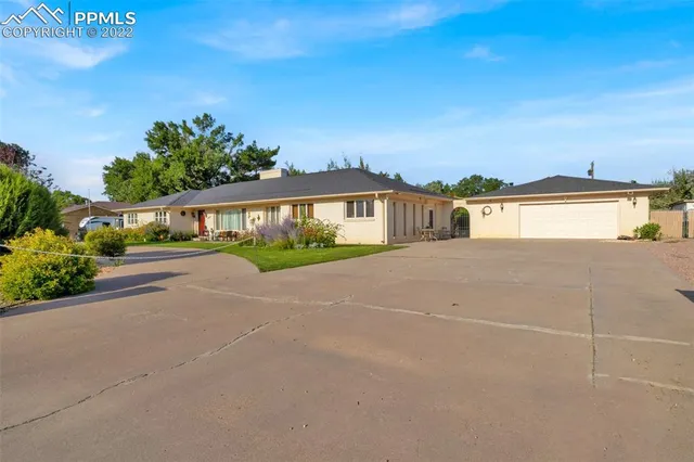 a view of swimming pool in front of residential houses