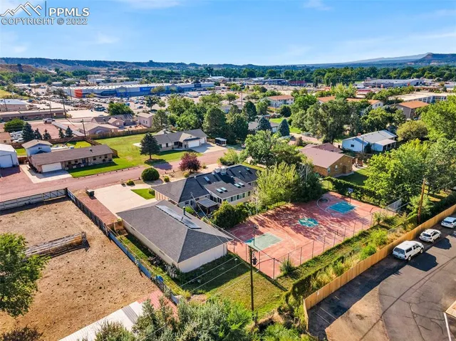 an aerial view of a house with a garden and lake view