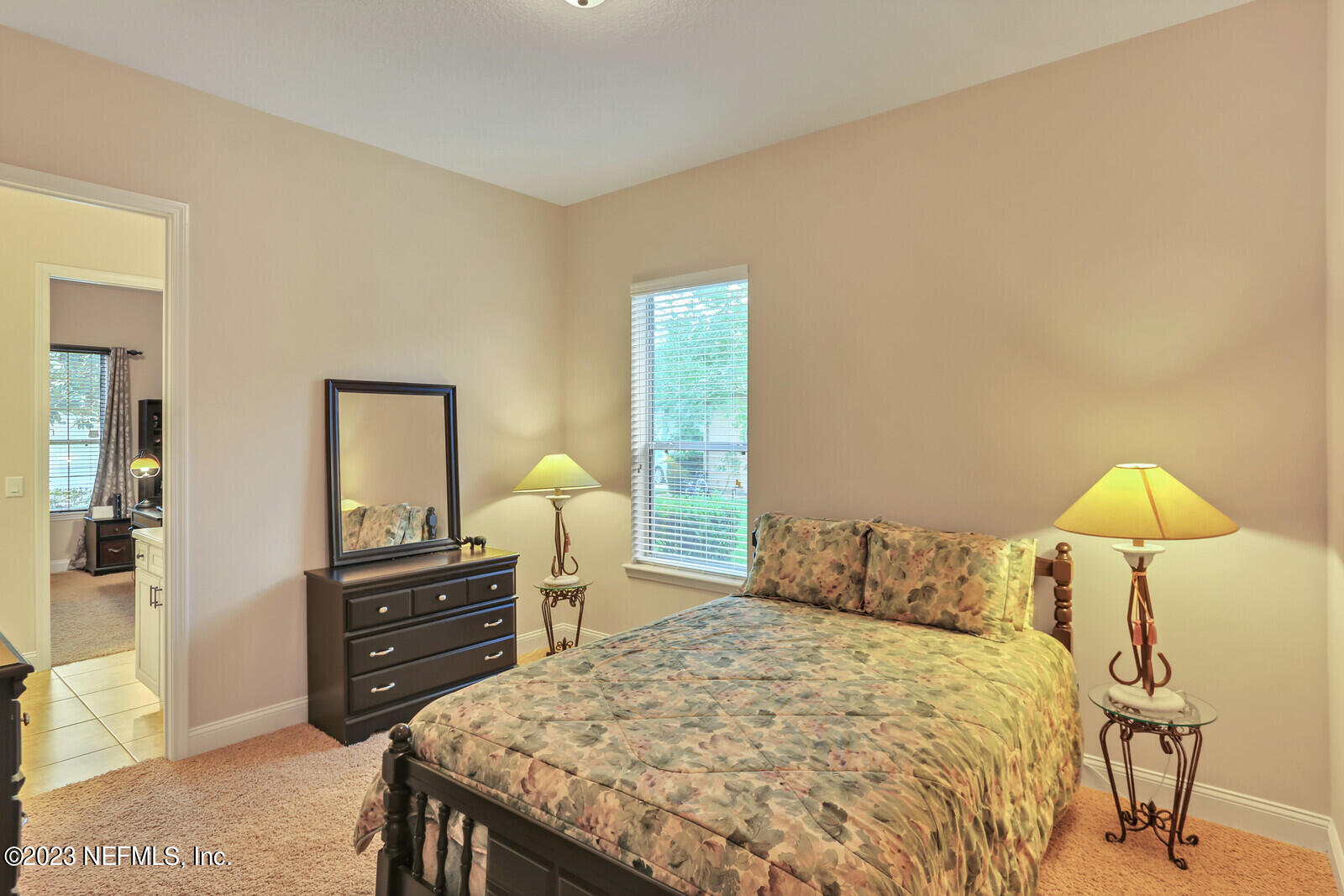 291 Ellsworth Circle St. Johns, FL 32259 - Photo 26 of 72 a bedroom with a bed and a lamp on dresser