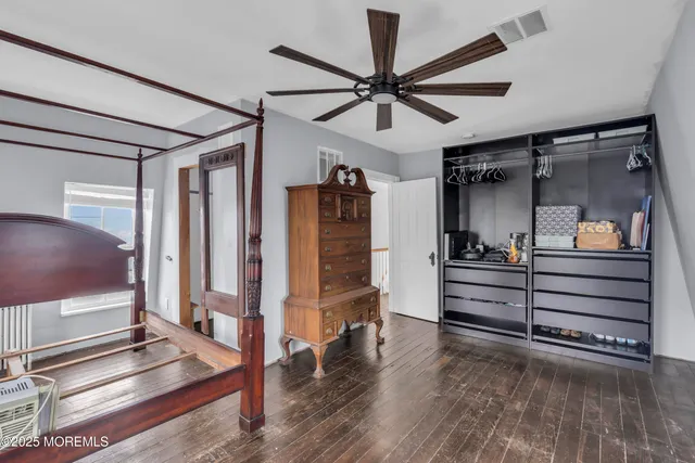 a view of an empty room and wooden floor