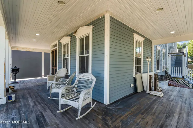 a view of a patio with table and chairs and wooden floor