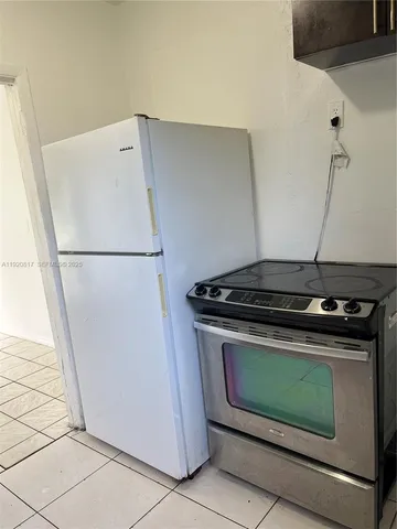 a stove top oven sitting inside of a kitchen