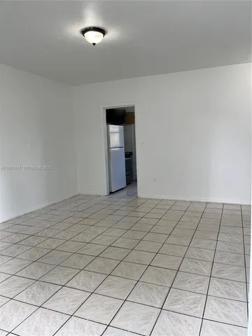 a view of an empty room and wooden floor