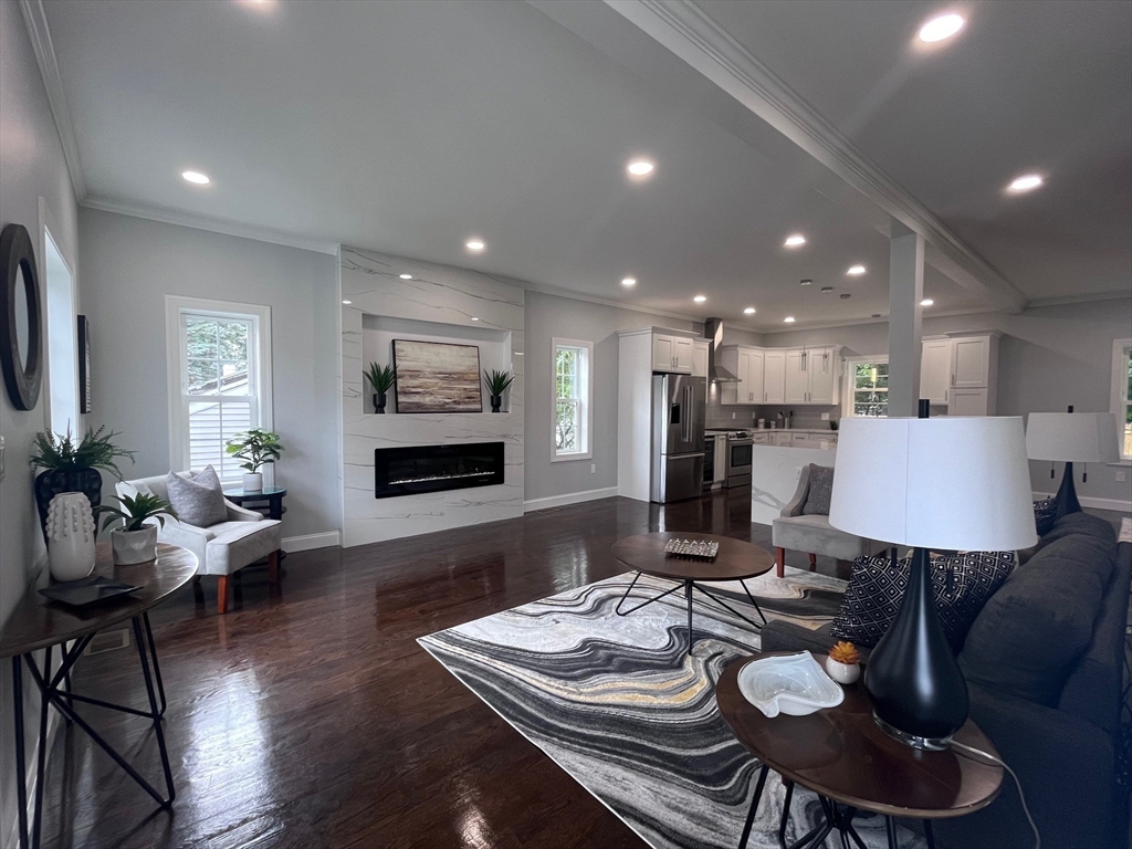 79 Holmes Road Dedham, MA 02026 - Photo 12 of 42 a living room with furniture kitchen view and a wooden floor