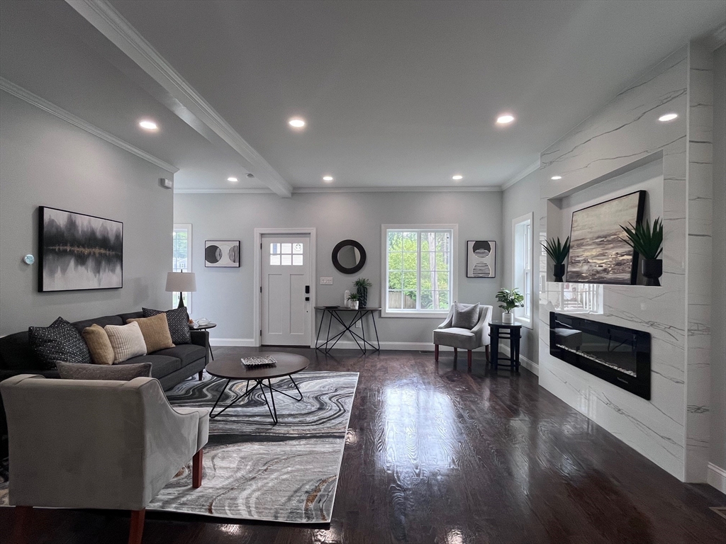 79 Holmes Road Dedham, MA 02026 - Photo 13 of 42 a living room with furniture and a fireplace