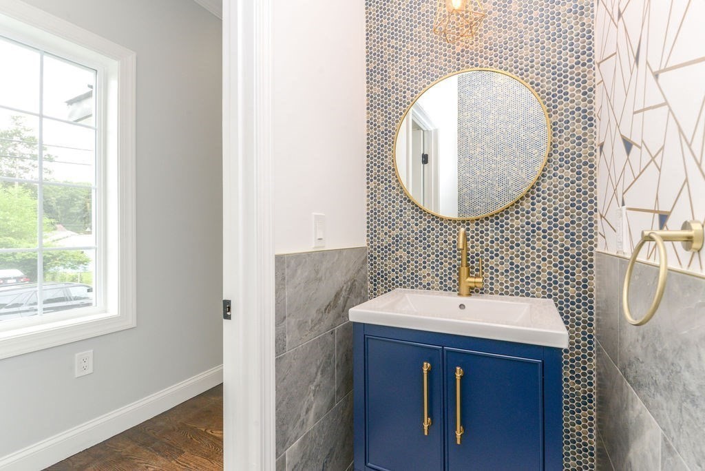79 Holmes Road Dedham, MA 02026 - Photo 16 of 42 a bathroom with a sink and a mirror